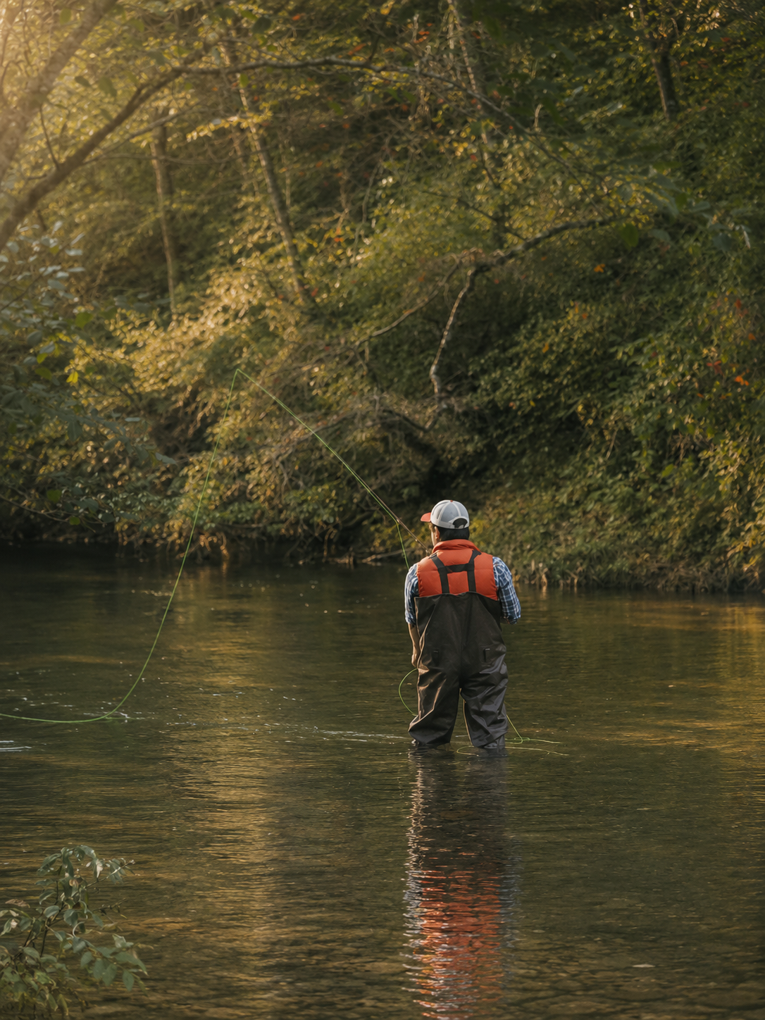 Javier Velazquez fly fishing on a North Georgia river at golden hour